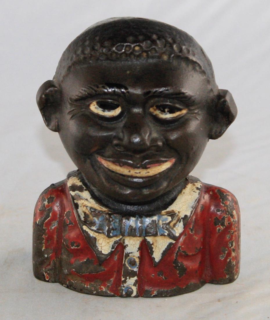 Young Negro Cast Iron Bank: Made in England circa 1900's. 4 1/2" T. Made of Cast Iron. Very Good Condition.
