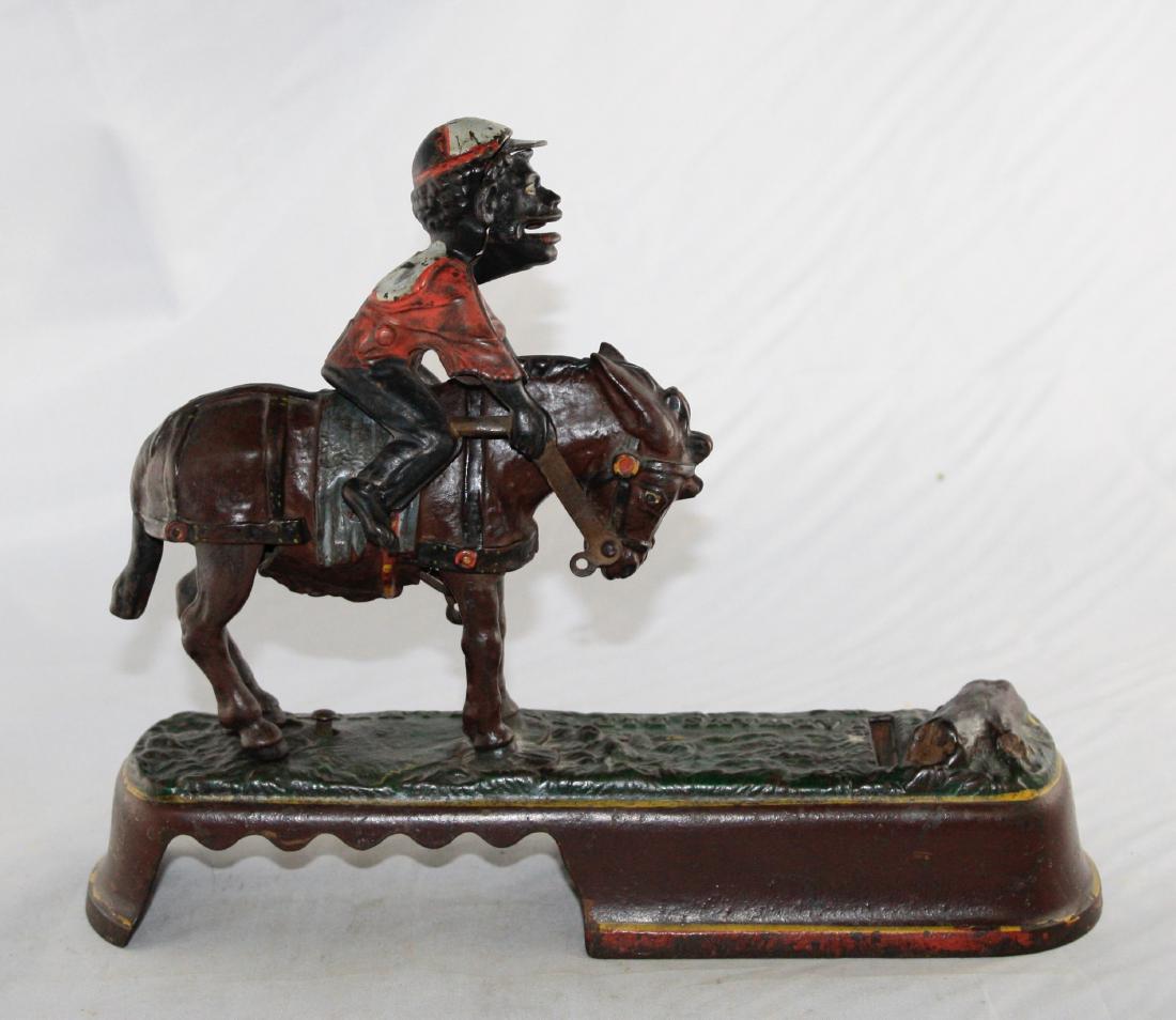 I Always Did Spise a Mule - Jockey Iron Bank: Made by J. & E. Stevens circa 1880's. Made of Cast Iron. Put your coin in the jockey's mouth, press the lever and the mule throws the jockey, depositing your coin. Fine Condition.