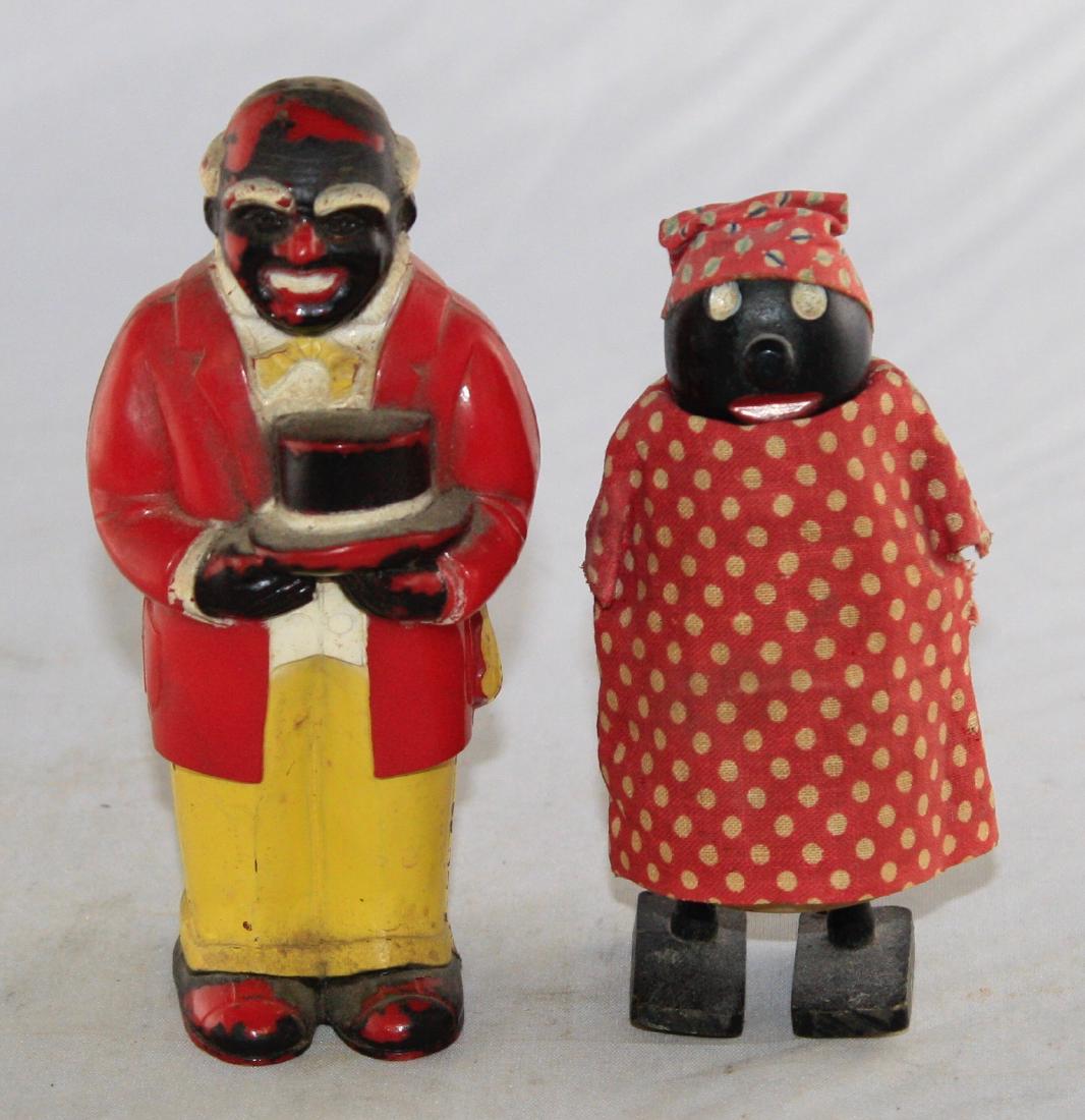 Two Black Themed Figures: Includes a Gentleman Salt or Pepper Shaker and a Walking Toy Mammy. The shaker is marked "F. & F. Mold & Die Works Dayton, Ohio". Made of plastic, wood and fabric. Fine Condition.