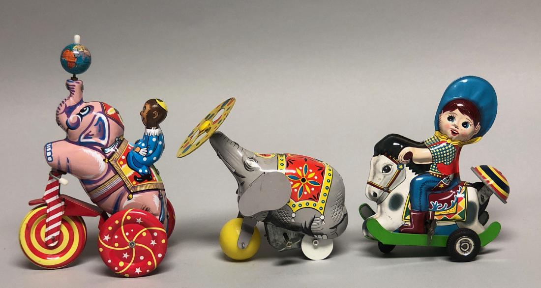 Three Tin Windup Toys: Grey Elephant marked "Tone" made in Japan. Little Cowboy Riding Horse marked Made in Japan". Elephant with Monkey Rider probably Chinese. Action: Grey Elephant moves forward while spinning his plate. 