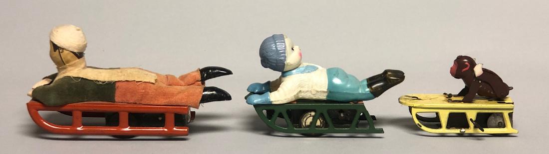 Three Windup Tin and Celluloid Sledding Toys (1 of 2)