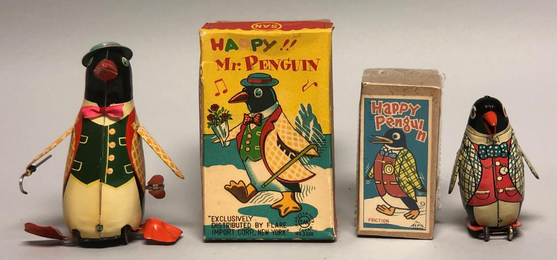Windup Happy Penguin & Friction Happy Penguin: Windup Happy Penguin marked "SAN" made in Japan. Action: Windup Happy Penguin moves forward and flaps his wings, making Penguin sounds. Friction Happy Penguin moves forward and flaps his wings. 4.5" -