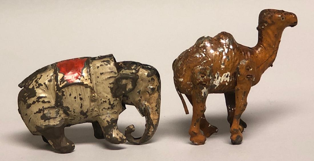 Tin Windup Hand Painted Elephant and Camel: Made in Germany. Made of Tin. Elephant 5.5" L. Camel is 5.25" T. Both work well. Good to Fine Condition.