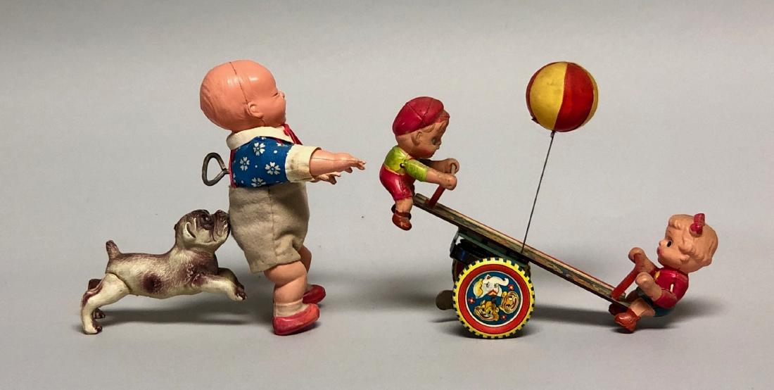 Windup Celluloid See Saw & Baby Bitten by Dog: Both probably made in Japan. Made of Celluloid and Tin. See Saw 7" L. Baby 5.75" T. Both work well. Very Fine Condition.
