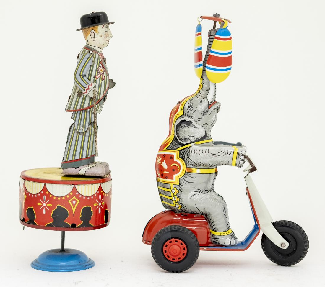 Two Tin Windup Toys: Included: Man Dancing on Stage marked "Made in Japan" and Circus Elephant Riding Tricycle marked "U. S. Zone Germany". Both toys work. 8" - 8 1/4" T. Made of Tin. Very Fine to Excellent Condition. Man