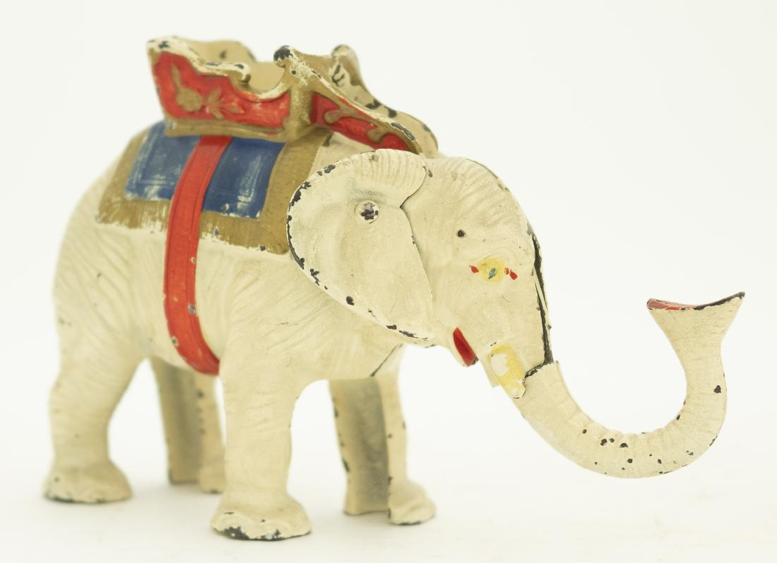 Hubley Elephant Cast Iron Mechanical Bank: Made by Hubley Lancaster, Pennsylvania - Circa 1935. Place your coin in his trunk. Pull his tail and he will deposit your coin into the howdah. Made of Cast Iron. Fine Condition. Replaced Screw.