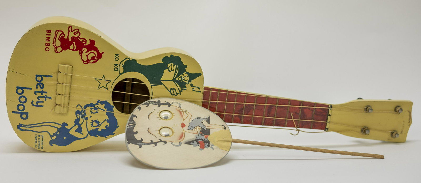 Betty Boop Guitar and Party Favor: Made in Japan. Party Favor made for France. 12" - 21" T. Party Favor with Googly Eyes. Excellent Condition. Back of Guitar slightly warping.