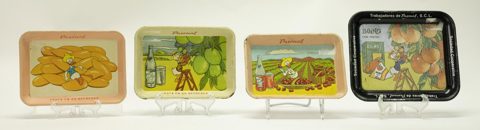 Four Donald Duck Trays, Pascual, Boing: Four Donald Duck Advertising Trays. Three are for Pascual and say "Pascual Fruta En Su Refresco. One is for Boing Con Fruta! 7" - 7 3/4" W. Fine to Excellent Condition.