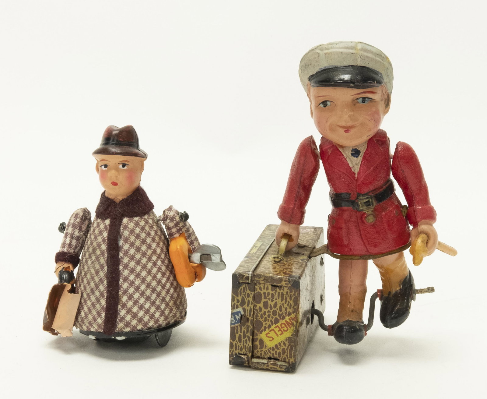 Celluloid Windup Men with Suitcases: Made in Japan. Made of Celluloid. Worked when attempted. Fine Condition. Smaller man with damage to luggage.