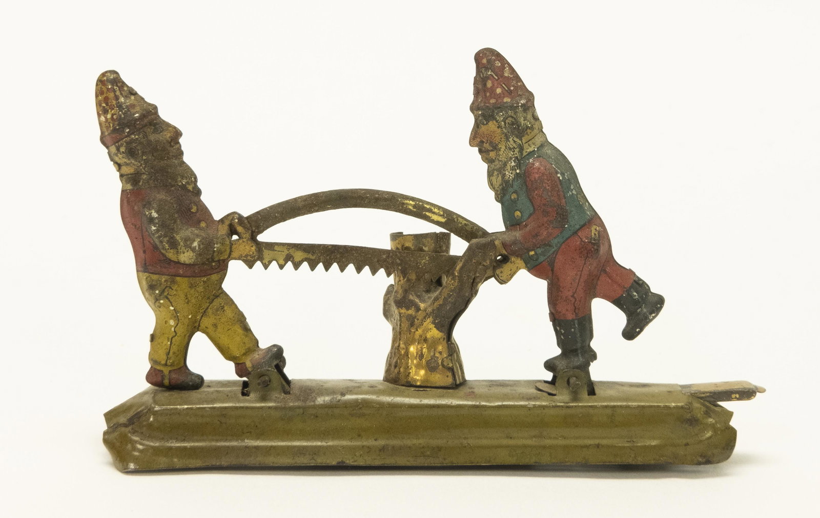 Gnomes Sewing Log Penny Toy: Made by Meyer. Made of Tin. Good Condition. Some Rust.