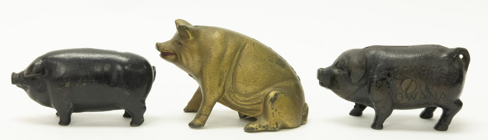 Three Pig Cast Iron Still Banks: Includes: Decker's Iowana, Seated Pig and Pig. 4 1/8" - 4 3/8" L. Made of Cast Iron. Fine to Excellent Condition,.