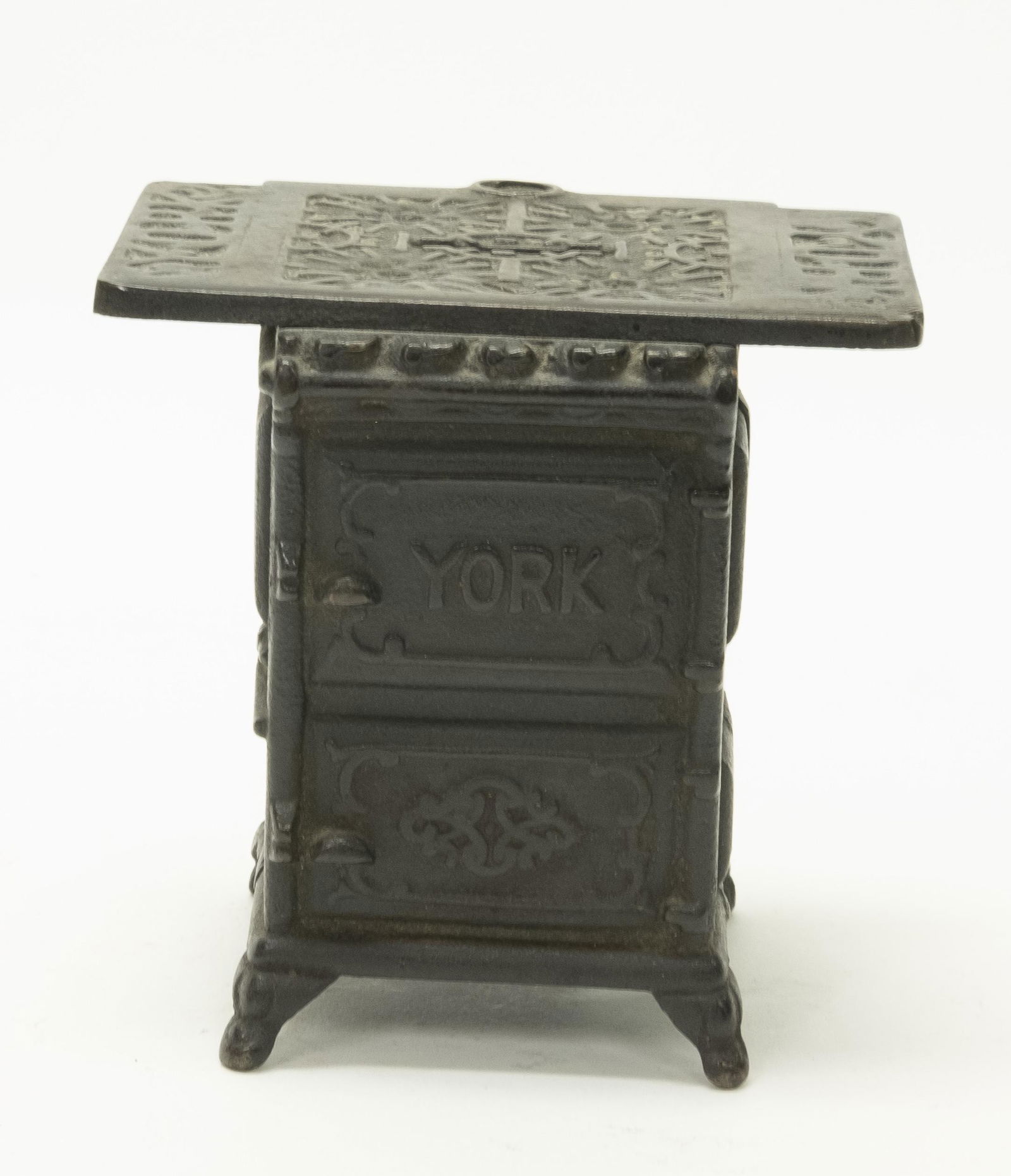 York Stove Cast Iron Still Bank: Made by Abendroth Bro’s. New York, NY - Circa 1900's. Made of Cast Iron. 3 7/8" T. Fine Condition. Replaced Screw.