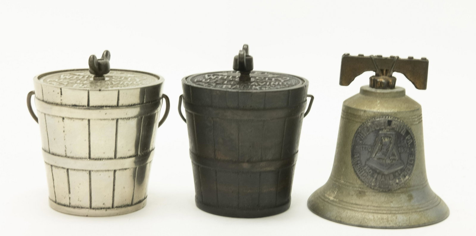 Two No. 2 White City Puzzle & Liberty Bell Banks: Includes: (2) No. 2 White City Puzzle Savings Pails (Electroplated and Nickeled Versions) by Nicol & Co. and Tin Liberty Bell. 3" - 3 1/4" T. Made of Cast Iron / Tin. Fine to Excellent Condition.