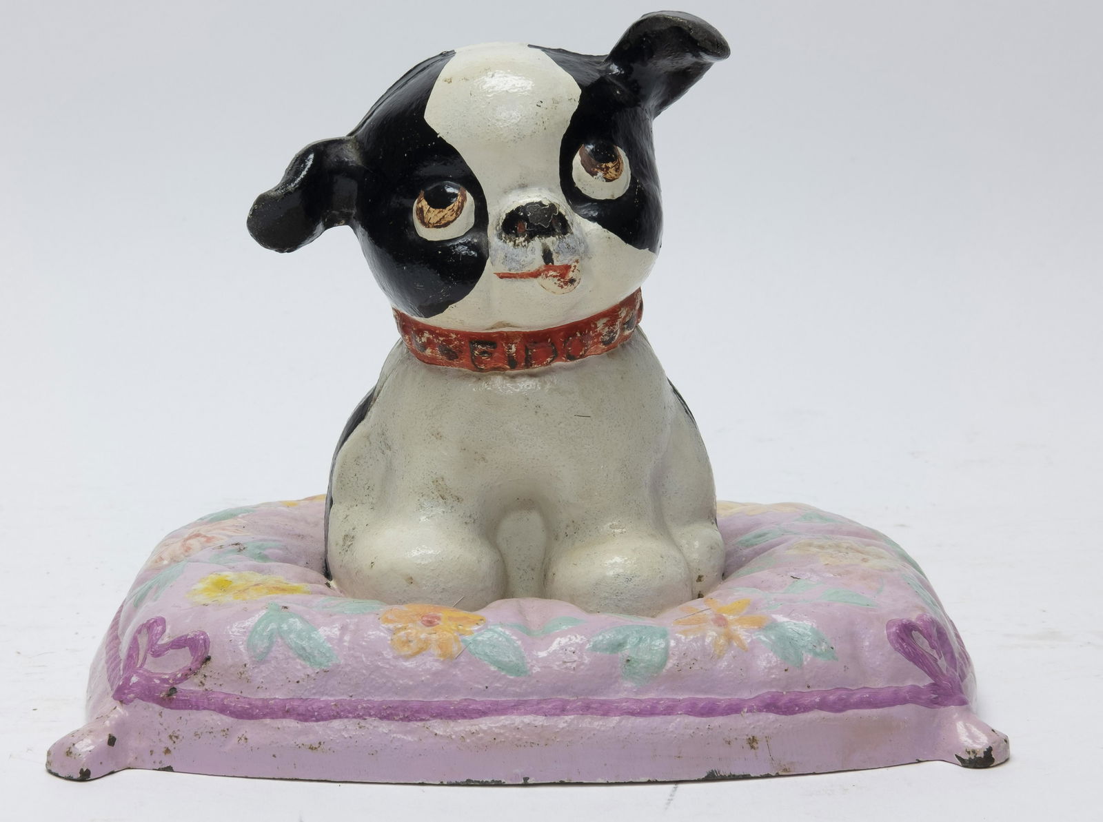 Hubley Fido on Pillow Cast Iron Bank: Made by Hubley Toy Company of Lancaster, PA. circa 1930's. Made of Cast Iron. 5 1/2" Tall. Excellent Paint Condition. The Pillow's paint has been restored, as has a tiny section of the paint on Fido's