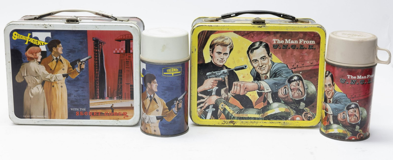 The Man From U.N.C.L.E. & Secret Agent Lunch Box: Both lunch boxes made by King-Seeley Thermos Co. The Man from U.N.C.L.E. in Good Condition, retains original thermos, some scratching and rust, thermos with some rust underneath. Secret Agent in Very 