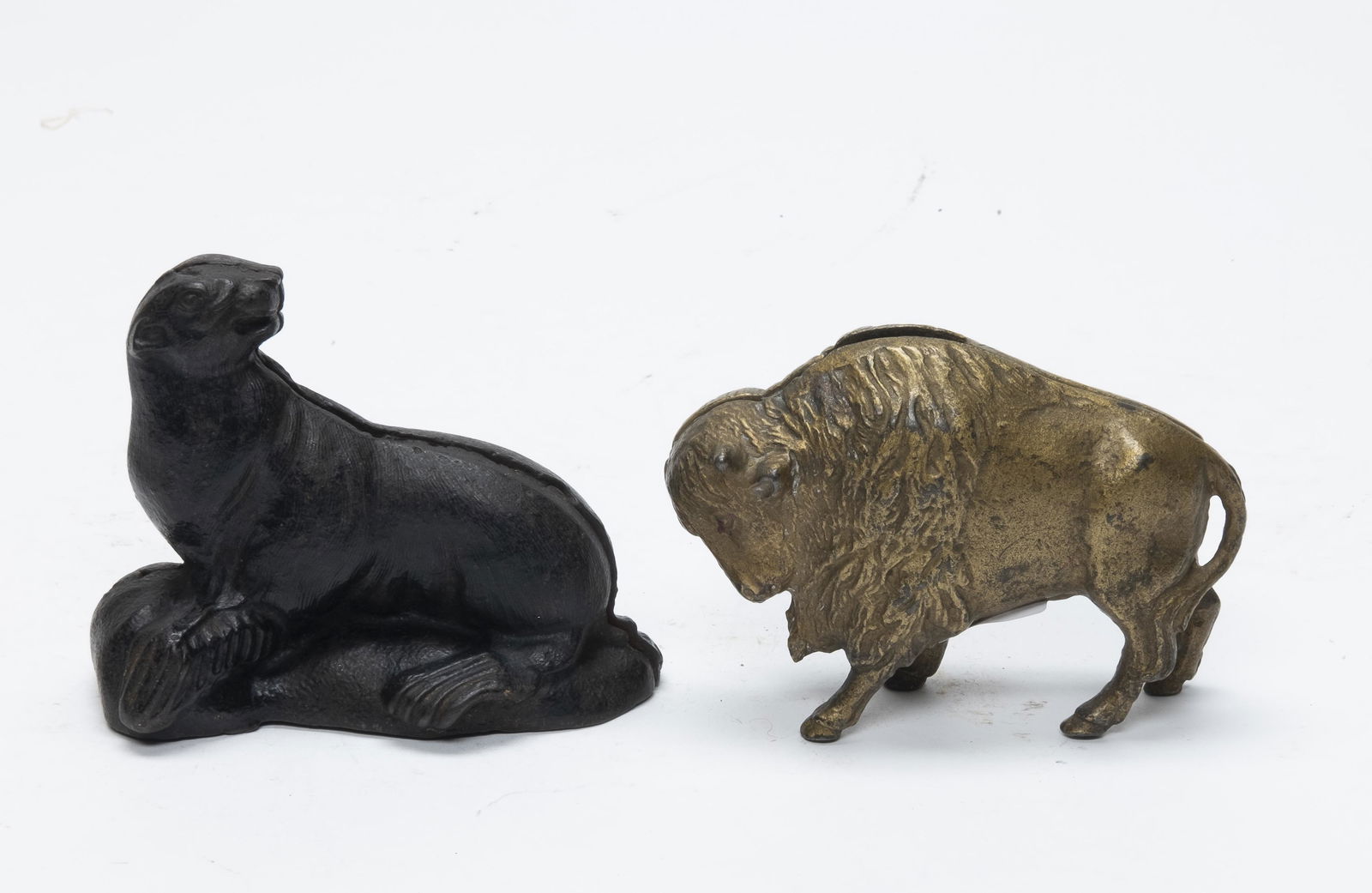 Buffalo and Seal on Rocks Iron Banks: Made by Arcade / A. C. Williams. 3 1/8" - 3 1/2". Made of Cast Iron. Fine Condition.