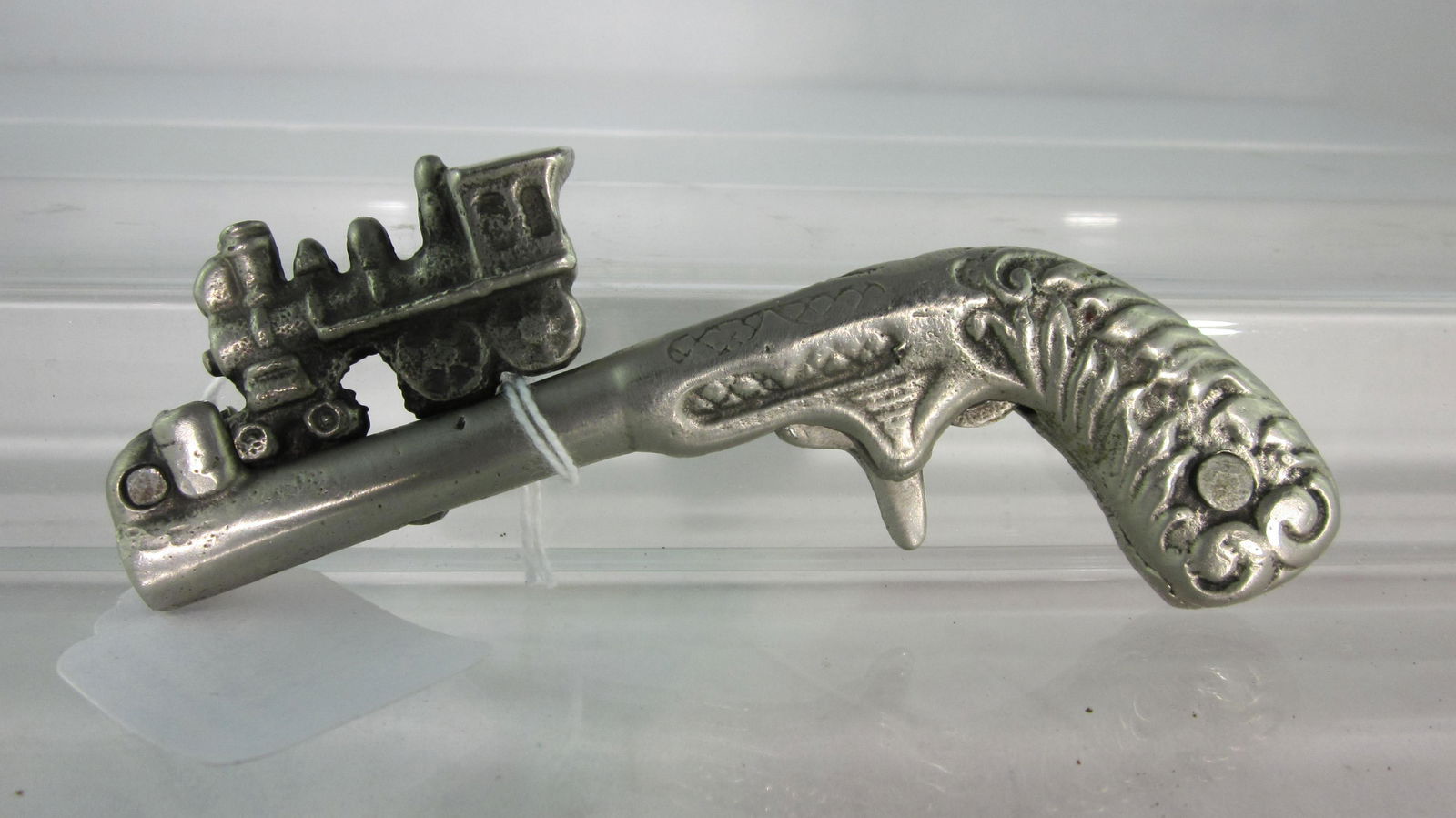 Kenton Cast Iron "Lightning Express" Cap Gun.: Single shot animated cap gun, 4 1/2" long, pull locomotive back to cock, pull trigger & train snaps to end of barrel. Circa 1913, 1 piece, condition excellent, no box. Rare piece.