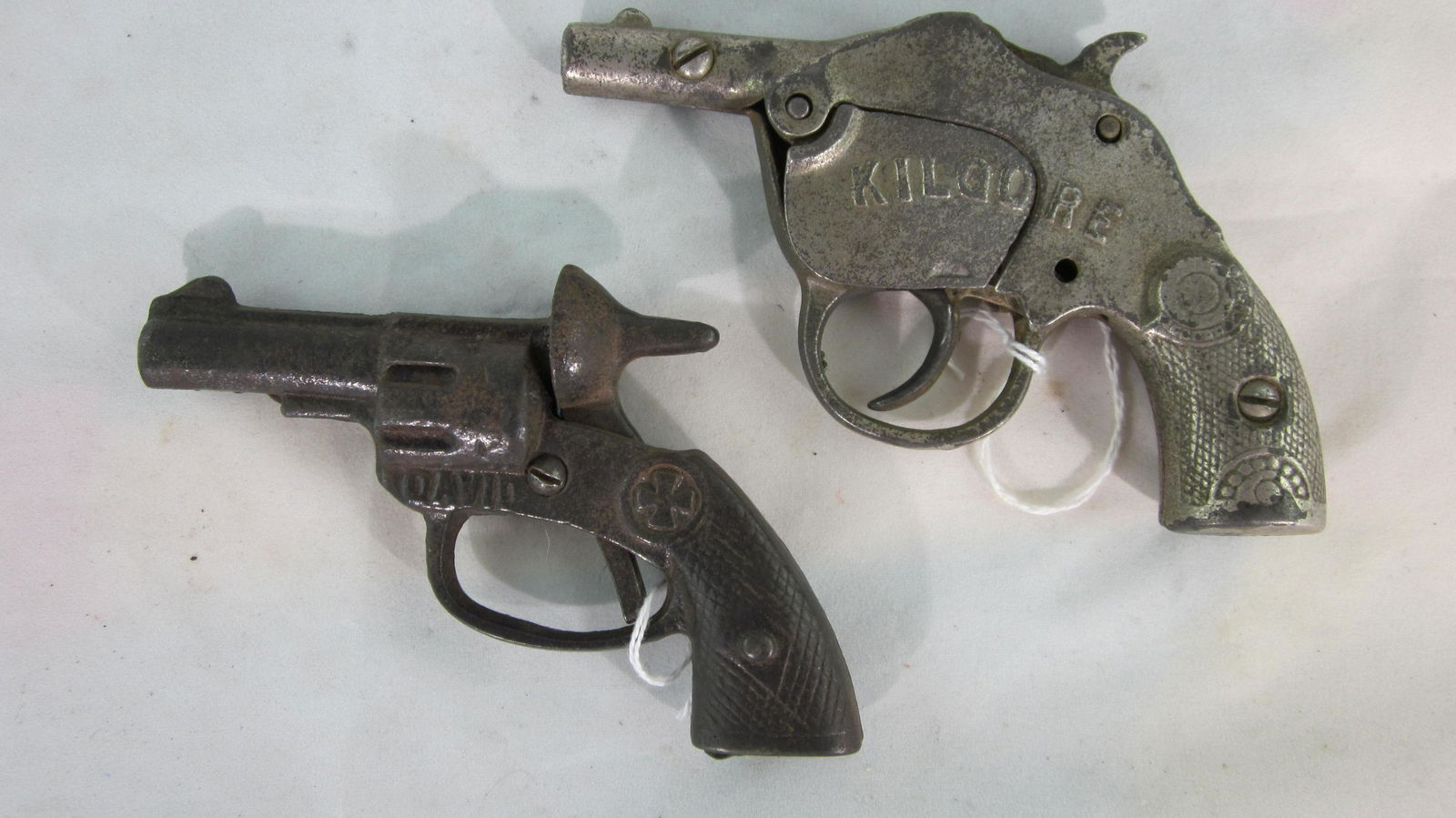 Two Early Kilgore Cap Guns.: "David" single shot Kilgore cap gun circa 1915, 4 1/2" long, with a Kilgore repeater cap roll pistol circa 1925, 5" long. 2 pieces. Condition very good, no boxes