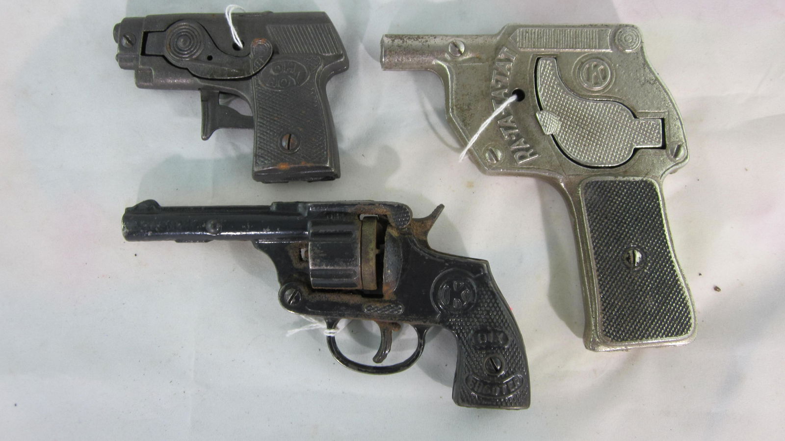 Three Kilgore Cap Guns Circa 1920s & 1930s.: Rare Kilgore "Machine Gun Ratatatat" circa 1938, 5" long, missing rotating rod to fire cap gun. Kilgore "Six Shooter" circa 1938, 6 3/4" long, "Six Shooter" has substantial rust. Also Kilgore "Oh Boy"