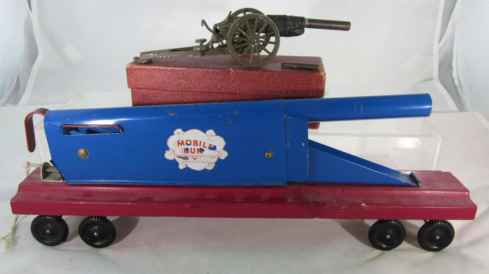 Belmar Mobile Gun & Warren Lines Cannon.: Belmar mobile gun circa 1960. Tinplate gun, wood base, plastic wheels, condition is very good. Also included is Warren Cannon circa 1939 with original box. Gun barrel is broken off & poor repair attem