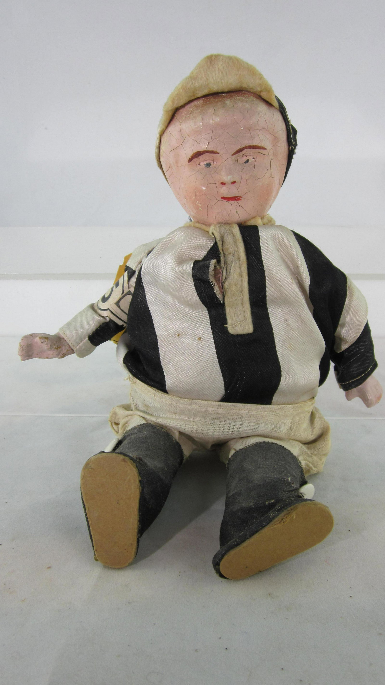 Horse Race Track Souvenir Doll Circa 1918.: Souvenir Jockey Doll in racing silks, 9 1/2" tall, bisque head & hands circa 1918. Label says "win or lose you still have me, a souvenir jockey I'll always be". 1 piece, condition very good. No box.