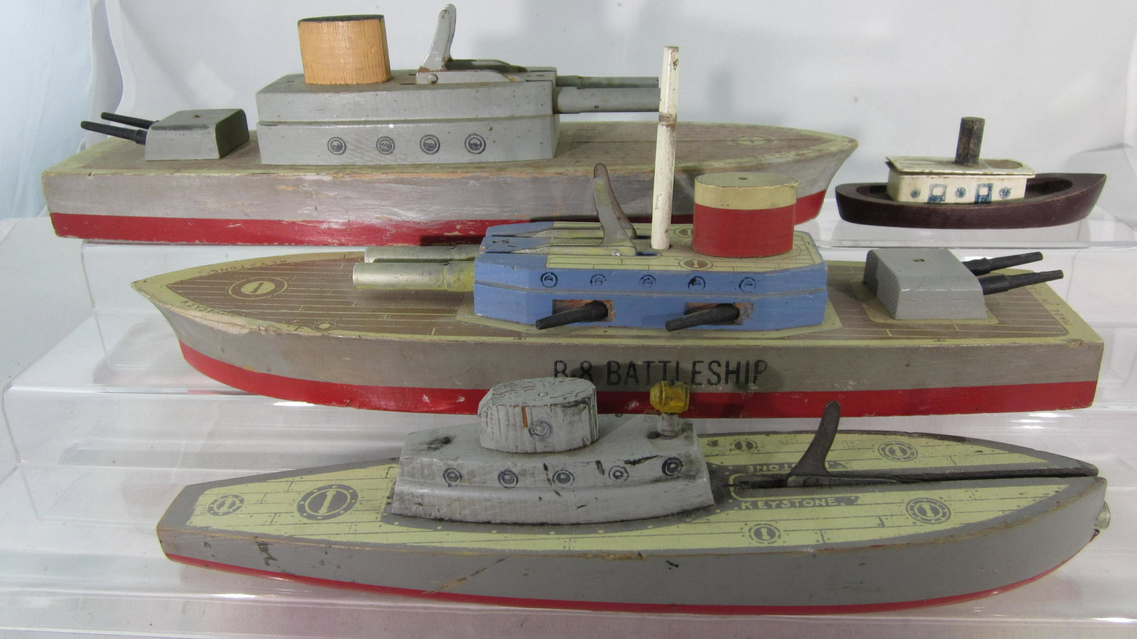 Keystone WWII Wooden Ship Assortment.: Keystone (USA) C42 Cruiser circa 1945, 13 1/2" long, U.S. Cruiser circa 1950, 14" long, U.S. Submarine circa 1950, 11" long, plus unknown maker tugboat, 1950s, 4 1/2" long. 4 pieces. Cruisers rear gun