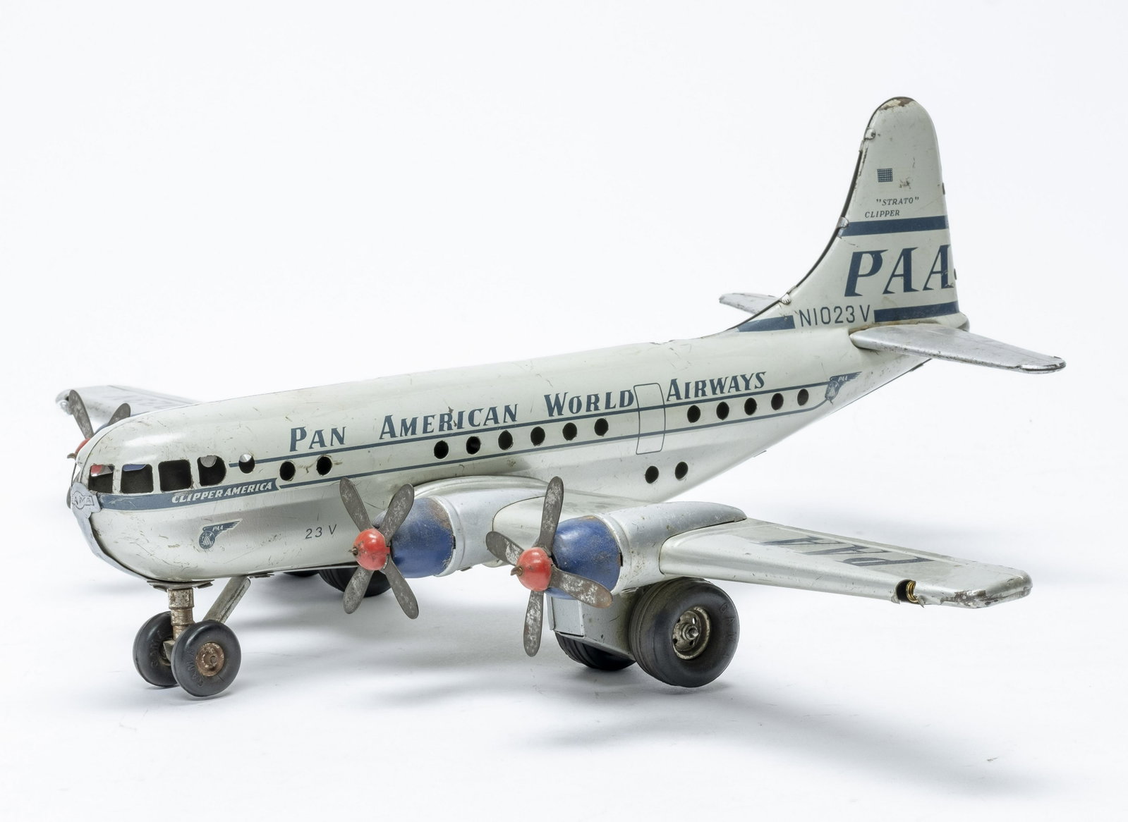 GAMA Pan Am Strato Clipper Airplane Toy: Made by GAMA, marked "Made in Western Germany". Made of Tin. 14 1/2" Long x 19 1/2" Wingspan. Friction function works, battery powered lights do not. Very Good Condition. One wheel loose. Missing one 