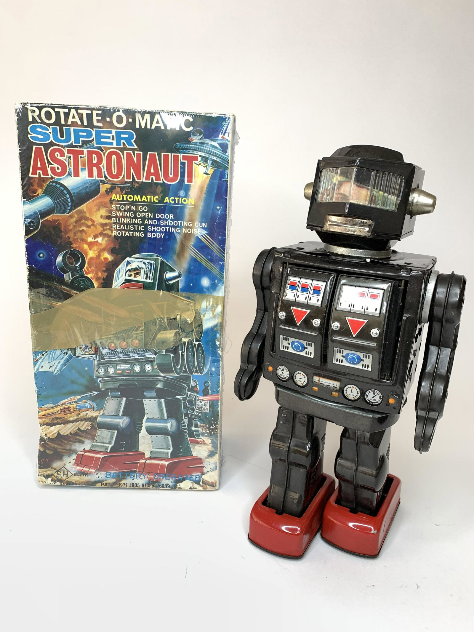 Rotate-O-Matic Super Astronaut SH Toy: SH. Japan. Circa 1974. Battery operated with original box. In working order. Automatic action includes swing open door, blinking and shooting gun, shooting noise and rotating body. 11 inches high. Pla