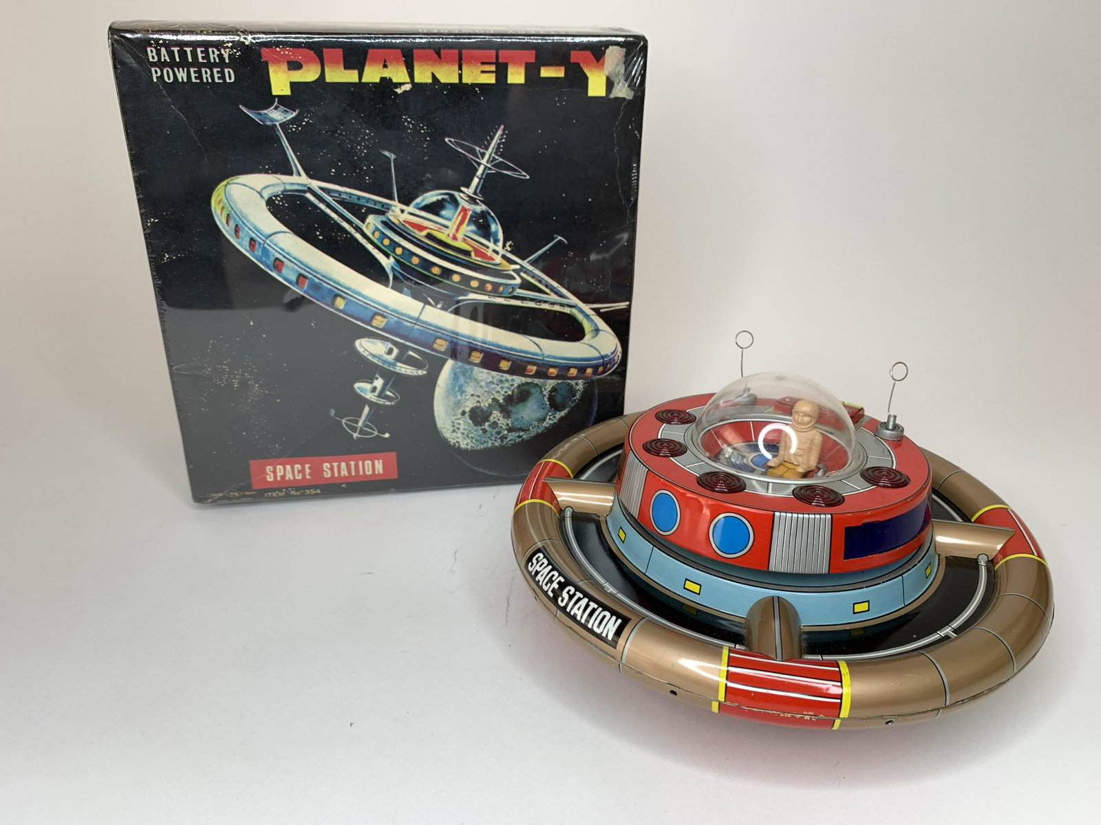 Battery Operated Planet -Y Space Station: Mark. Japan. Circa 1960s. Includes original box. In working order. 8 inches in diameter. Tin and Plastic. Excellent Condition.