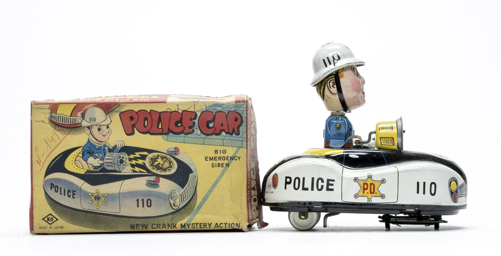 Yoshiya Police Car w/ Box Japan: Made by Yoshiya of Japan (KO) 1955. Made of Tin. 5 1/2" Long. Worked when tested. To work the toy, you turn the crank. The car drives around erratically while a siren sound is emitted. Fine Condition 
