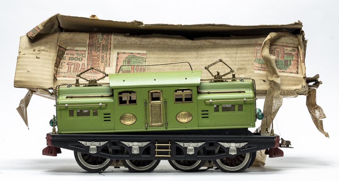 Lionel 408 F Locomotive with Box: Lionel Corporation. American - 1930's - 17" Long. In as found condition. The cab and wheels are loose from the chassis. Missing one rail on top of the cab. Excellent Lithography. Must be reassembled. 