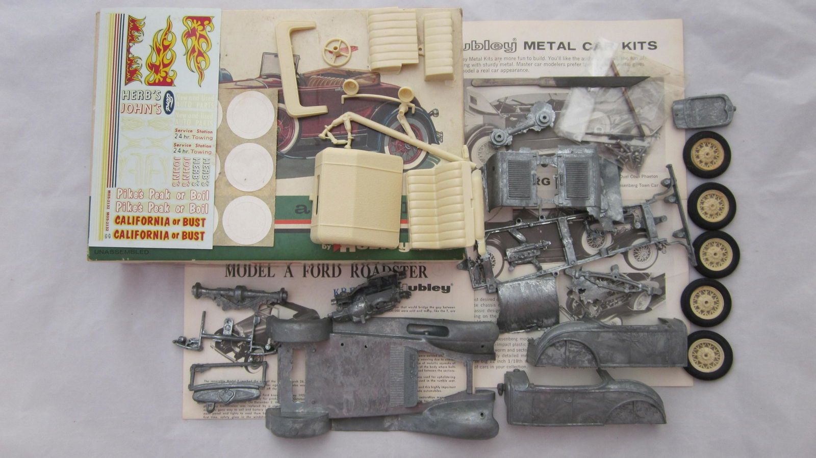 Hubley Metal Model A Ford Model Kit: Hubley 1/24th scale Model A Roadster kit circa 1960s, rubber tires, plastic seats, steering wheel & wheels, along with AMT '41 Ford Woody in 1/25th scale. Both sets are Mint, Roadster is in very good