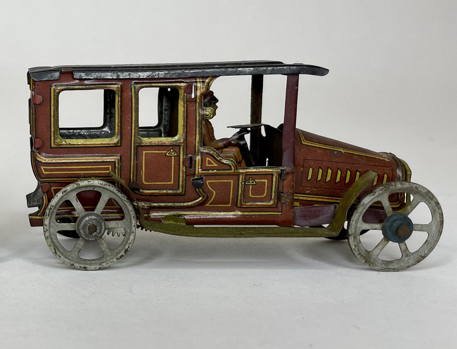 German Penny Toy Limousine with Driver: Made in Germany. Circa 1920. Wind-Up. 4 1/2 inches long. Excellent Condition.