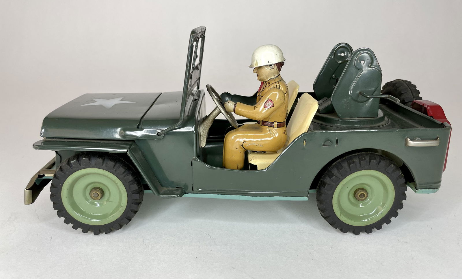 Friction Japanese Antiaircraft Vehicle with Drive: Measures 11 1/2 inches long. Includes driver, but missing antiaircraft gun and figure. Excellent Condition.