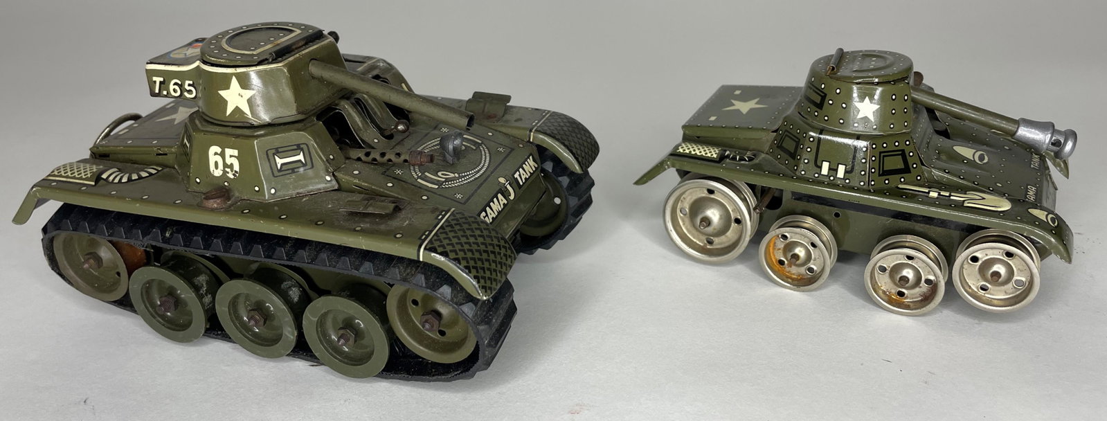 Two Gama Tanks: Montage 65-3 (Missing one machine gun and antenna) and other tank missing treads. Circa 1950s. 6 1/2 inches long. Excellent Condition.
