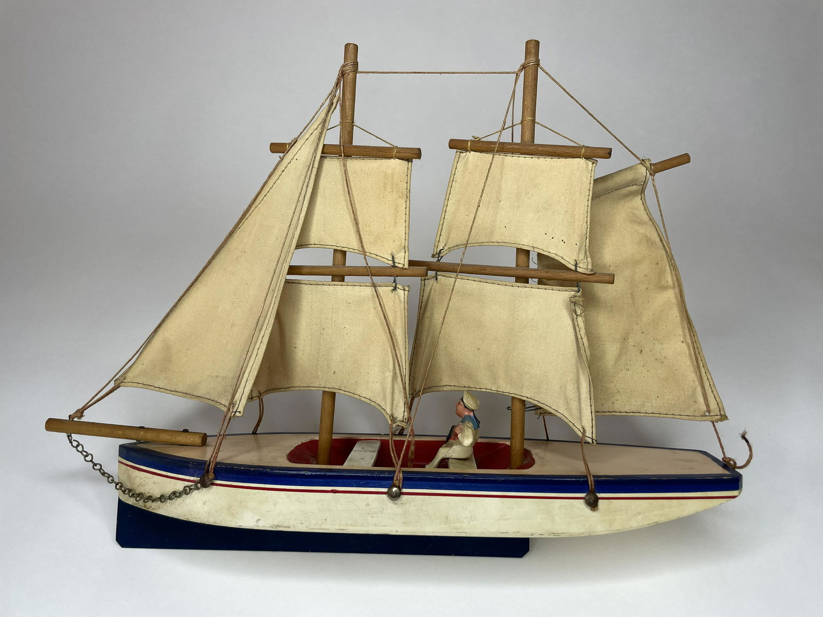 Sailing Yacht, France: French, circa 1930. With composition figure playing the accordion. Two masts with six sails. 14 inches in length and 10 1/2 inches high. Excellent Condition. Wonderful form.
