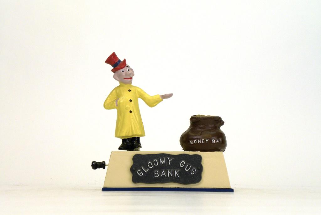 Gloomy Gus Bank: Reynolds Toys - 1990's. Place a coin in his hand and pull the lever out, he leans right depositing coins to the money bags. Mint Condition.