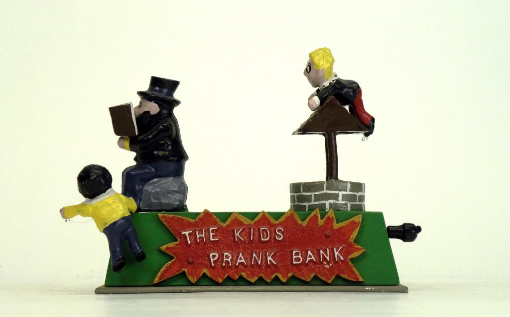 The Kids Prank Bank: Reynolds Toys - 1980's. Place a coin between his book and face and pull the lever back, he falls backwards and the coin is deposited to the well. Mint Condition.