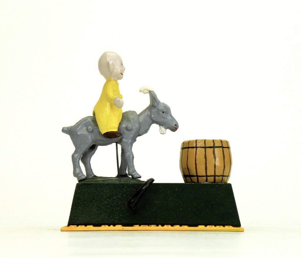 The Kid Savings Bank: Reynolds Toys - 1980's. Place a coin between the Kid's horns and depress the activating lever quickly and the coin is deposited to the barrel. Mint Condition.