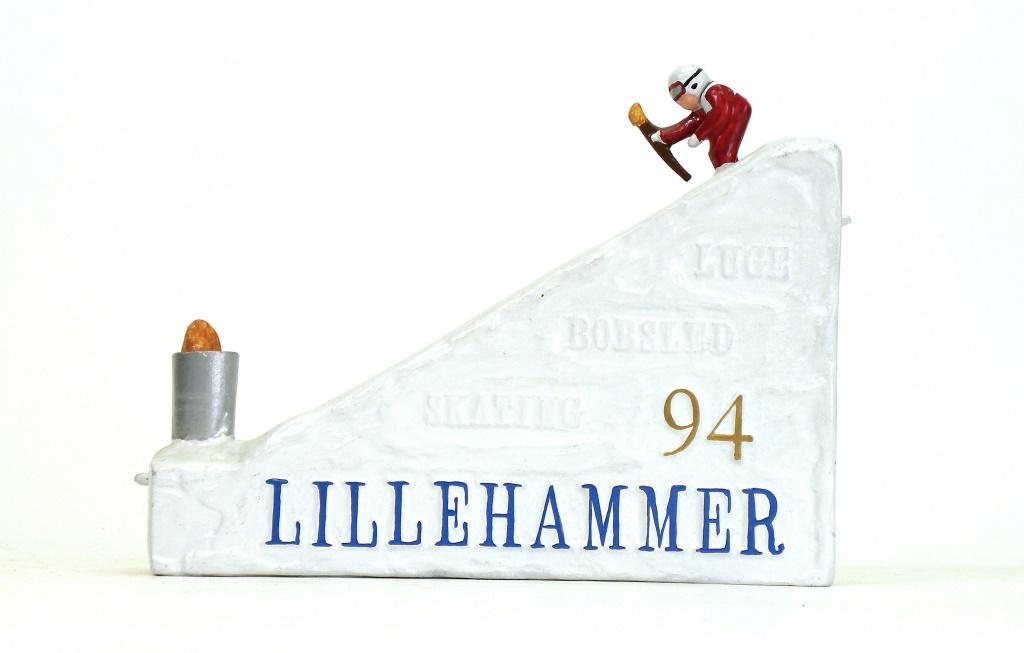 Norway Bank: Reynolds Toys - 1994. Made to commemorate the Winter Olympic Games of 1994 that were held in Lillehammer, Norway. Set the flames down in the cauldron, depress the lever and the skier comes down, the f
