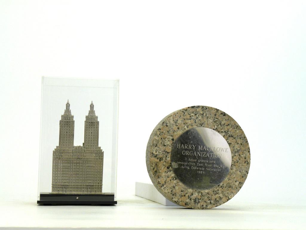 Two Harry Macklowe Development Souvenirs: American - 1980's / 2000's. One is a paperweight of the actual granite core removed from the East River Sea Wall and the other is the San Remo Apartments owned by the Macklowe Company.