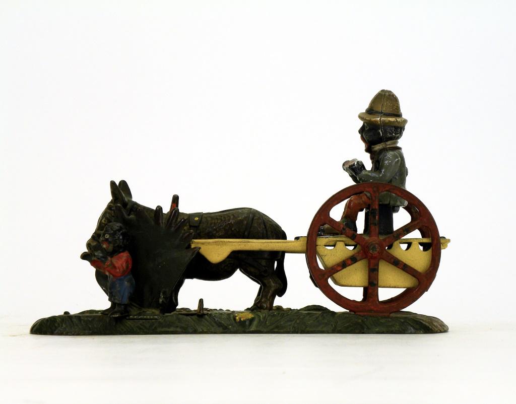 Bad Accident Iron Mechanical Bank: J. & E. Stevens Company. Cromwell, Connecticut - 1890's. Overall in good condition, however, the yellow cart is repainted and the boy figure is a modern replacement.