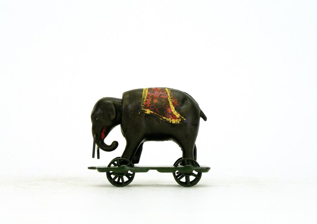 Elephant with Tusks on Wheels Iron Bank: American - 1890's - 4.375" Long. This is the rarest of the nodding head Elephant Platform Banks. There are fewer than 15 known examples of this bank. The original platform has been repainted. Excellen