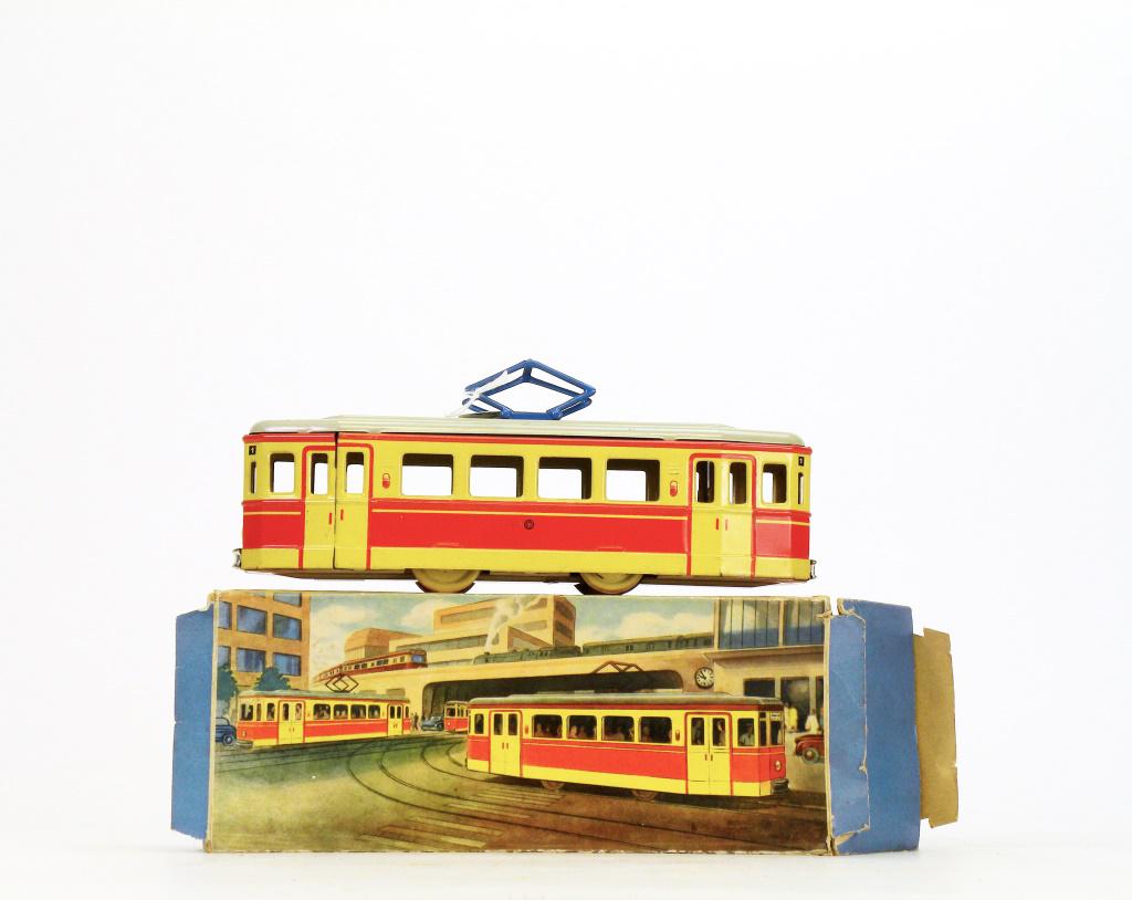 Trolley with Box: Probably Spanish - 1940's - 10" Long. This is a friction driven trolley made of tin with its original cardboard box. It works very well. Pristine with Box.