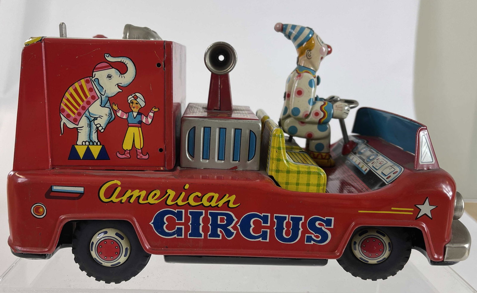 American Circus Truck: Battery Operated. Made by Excelo. Japanese - 1950's - 9" Long. We did not test this toy, but the battery housing is pristine. Pristine Condition.