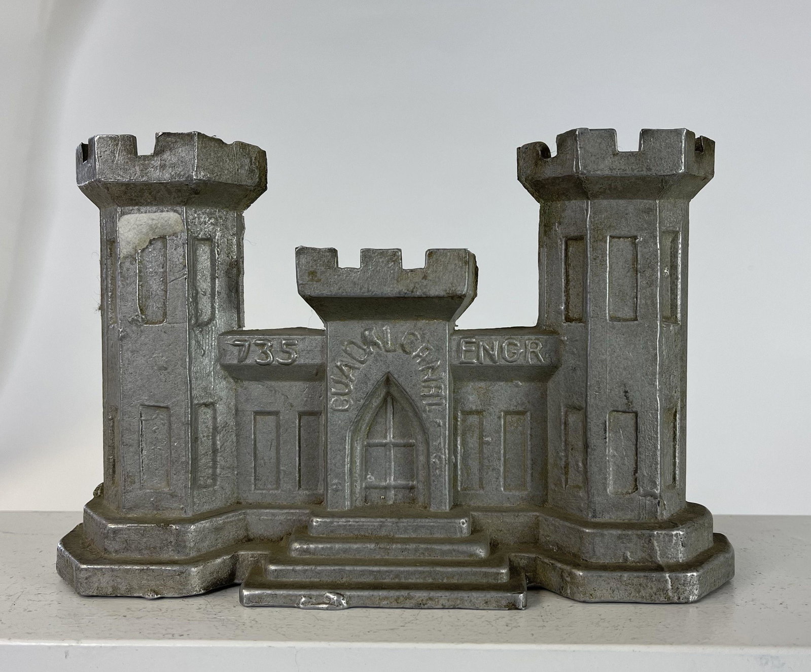 Guadalcanal Engr Doorstop: American - 1930's - 8" Long. Made of aluminum or similar type alloy. Excellent Condition.