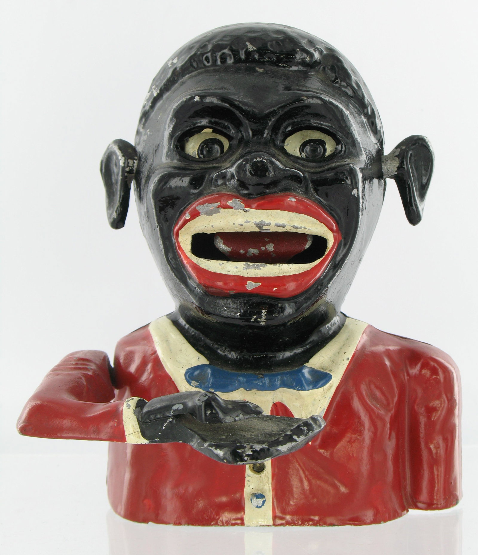Jolly Man Sonny Boy Mechanical Bank: Made by Robert Starkies. Aluminum. Circa 1945. Eyes move down, raised chevrons on arm with lattice base. "Patent 601362" embossed inside the back piece. Lattice embossed "Starkies Patent 32587 and Reg