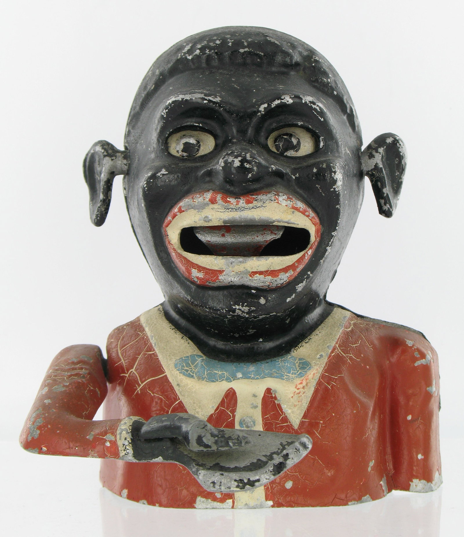Jolly Man Sonny Boy Mechanical Bank: Made by Robert Starkies. Aluminum. Circa 1945. Eyes move down, raised chevrons on arm with lattice base. "Patent 601362" embossed inside the back piece. Lattice embossed "Starkies Patent 32587 and Reg