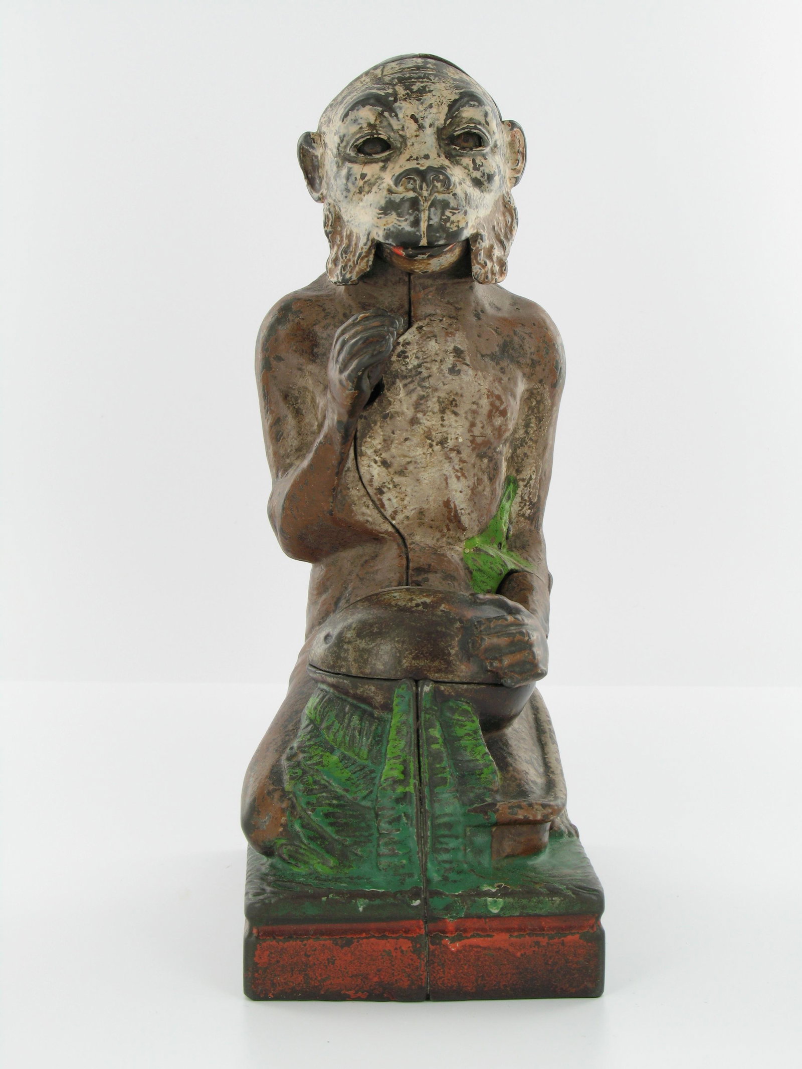 Monkey and Coconut Mechanical Bank: Made by J. & E. Stevens. Cromwell, Connecticut. Circa 1886. Cast Iron. With red base. Very Good Condition.