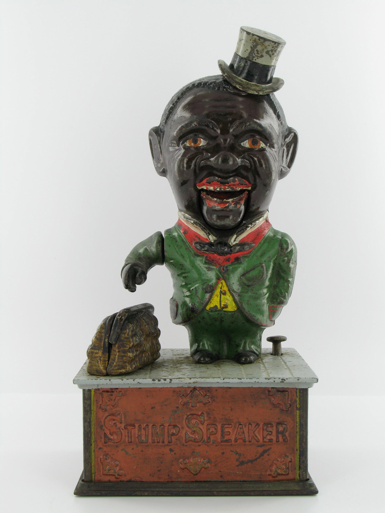 Stump Speaker Mechanical Bank: Made by Shepard Hardware Company. Buffalo, New York. Circa 1886. Cast Iron. Restored top plate. With brown face. Very Good Condition.
